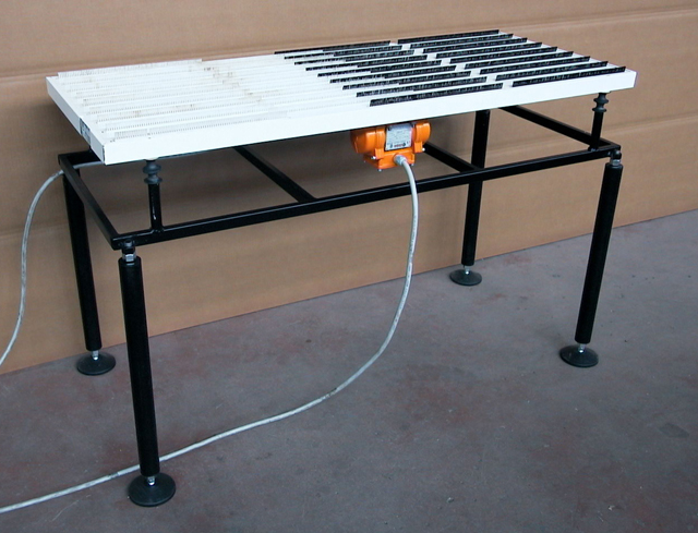 Low friction vibrating table for handling sheet metal